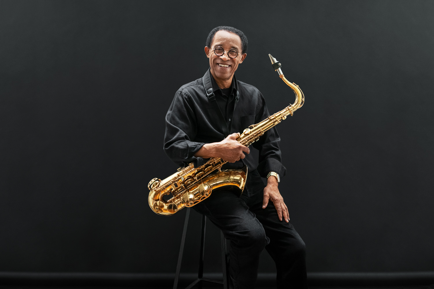 Girma Woldemichael seated with saxophone